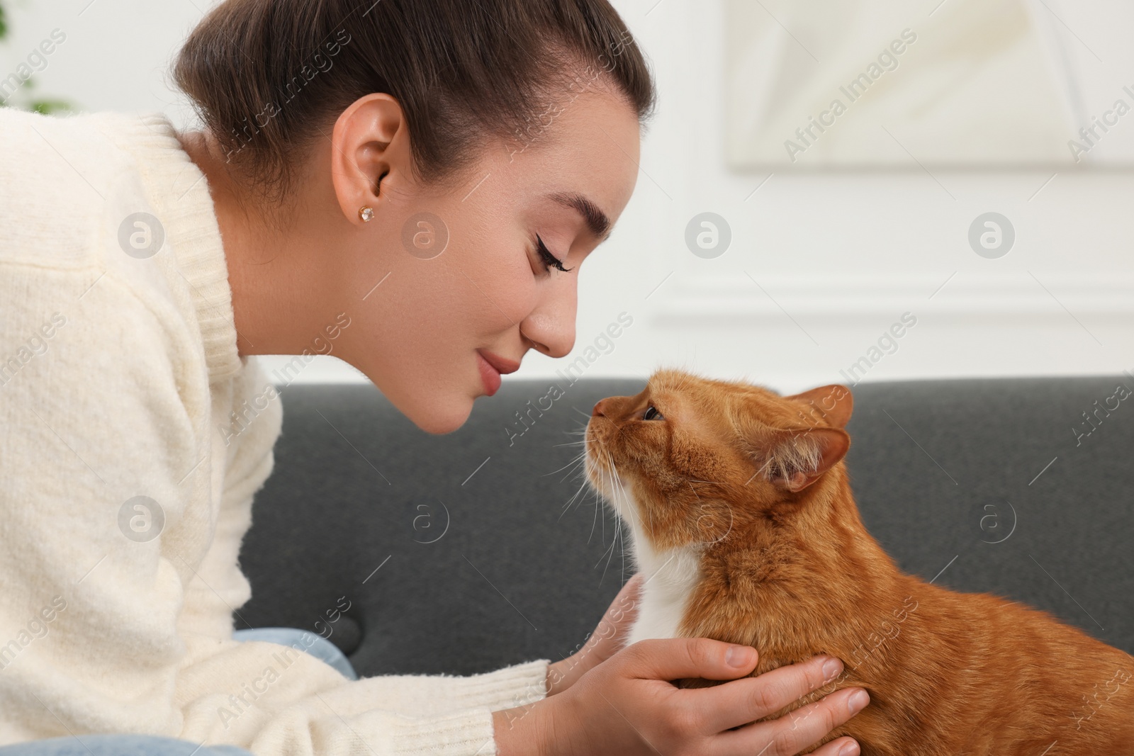 Photo of Beautiful woman with cute cat at home