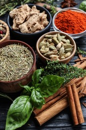 Photo of Different natural spices and herbs on wooden table