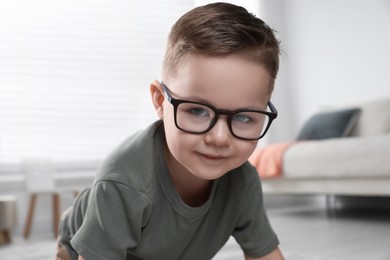Photo of Cute little boy in glasses at home