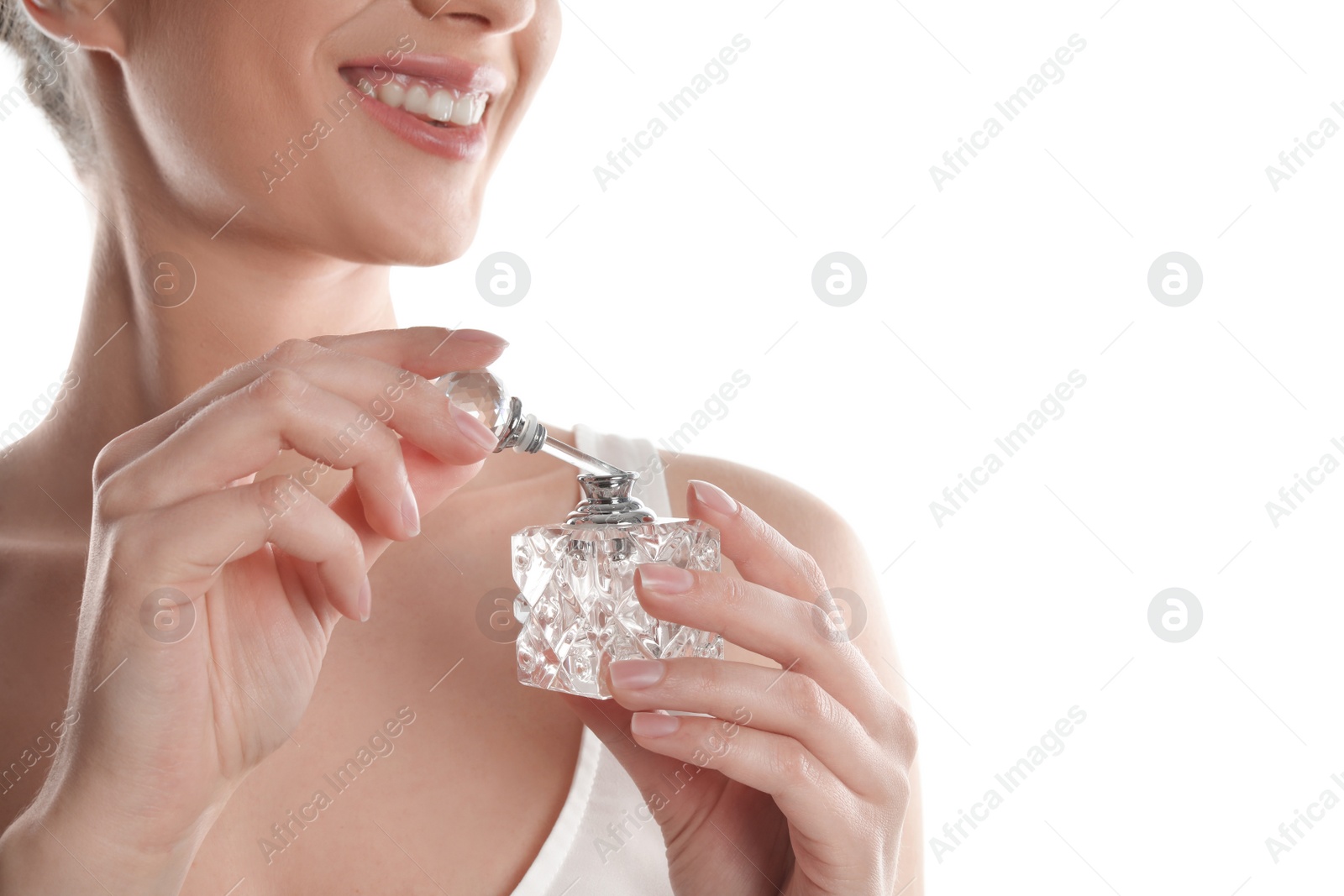 Photo of Young woman applying perfume on white background, closeup