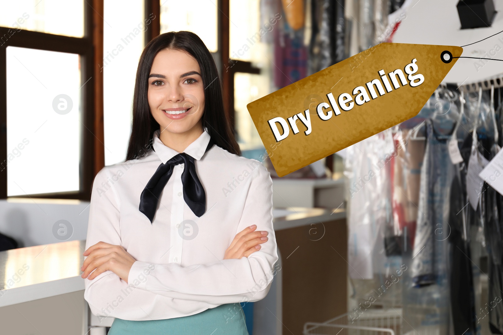 Image of Portrait of happy worker near garment conveyor at dry-cleaner's