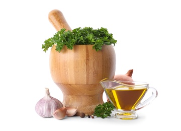 Photo of Mortar with green fresh parsley, vegetables and oil on white background