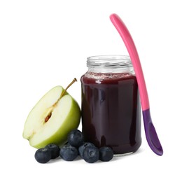 Photo of Jar with healthy baby food, spoon, fresh blueberries and half of apple isolated on white