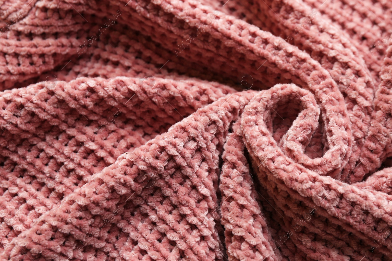 Photo of Beautiful pink knitted fabric as background, closeup