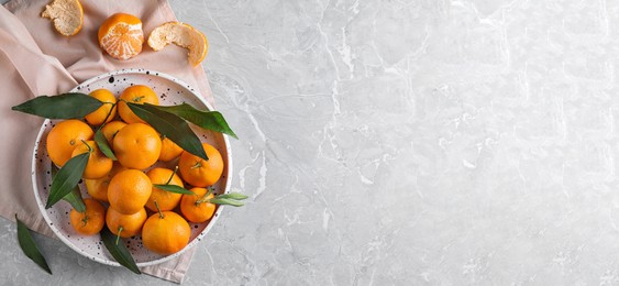 Image of Flat lay composition with fresh ripe tangerines on light grey marble table, space for text. Banner design