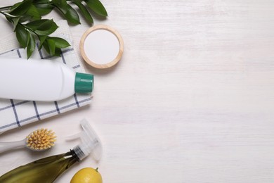 Photo of Flat lay composition with different cleaning supplies on light wooden background, space for text