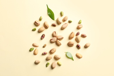 Composition with organic pistachio nuts on color background, flat lay