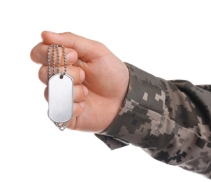 Photo of Man in camouflage uniform holding military ID tag on white background, closeup
