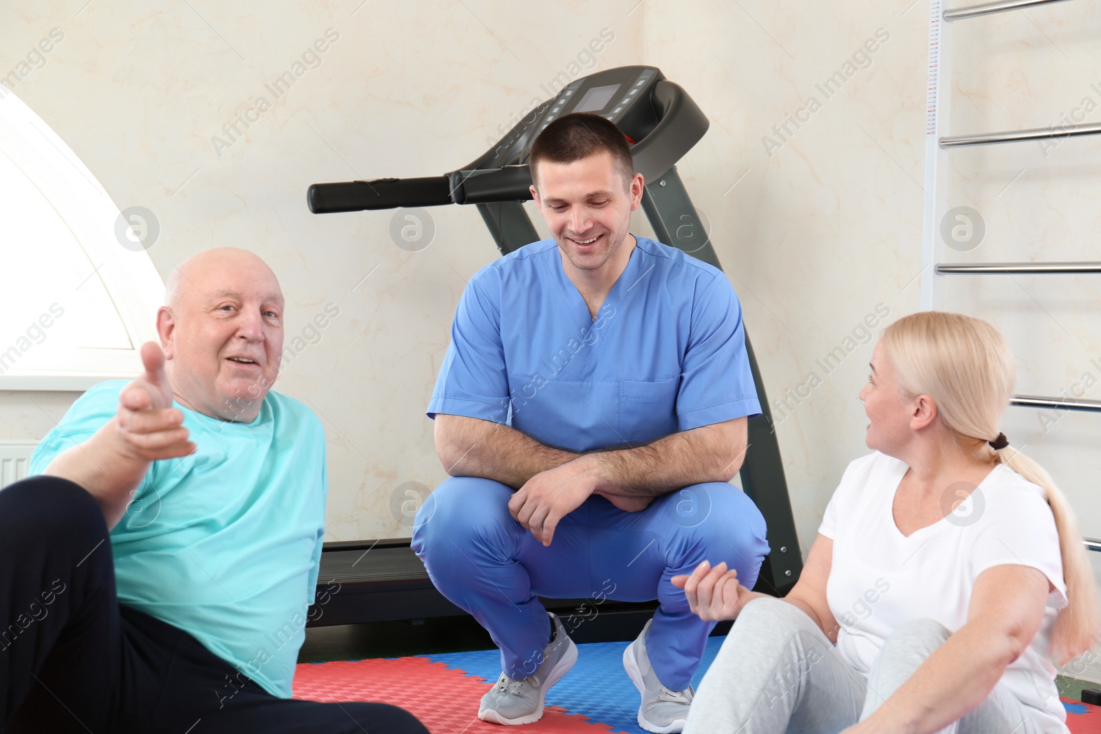 Photo of Patients with physiotherapist in modern rehabilitation center