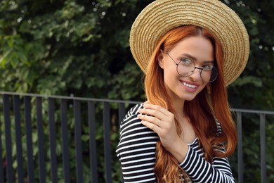 Photo of Portrait of beautiful woman in glasses outdoors, space for text