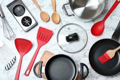 Photo of Flat lay composition with clean cookware on marble background
