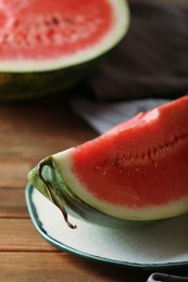 Photo of Sliced fresh juicy watermelon on wooden table, closeup