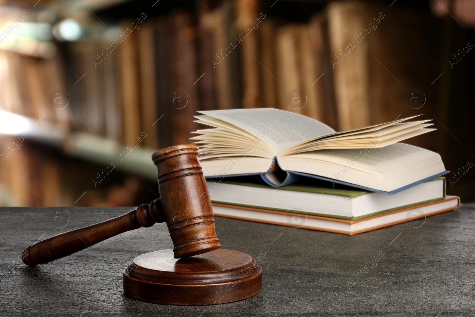 Image of Law. Judge's gavel and books on grey table indoors