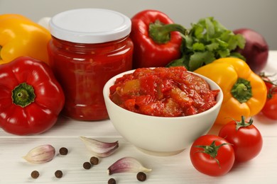 Photo of Delicious lecho and fresh ingredients on white wooden table