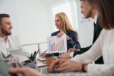 Photo of Businesspeople having meeting in office. Management consulting