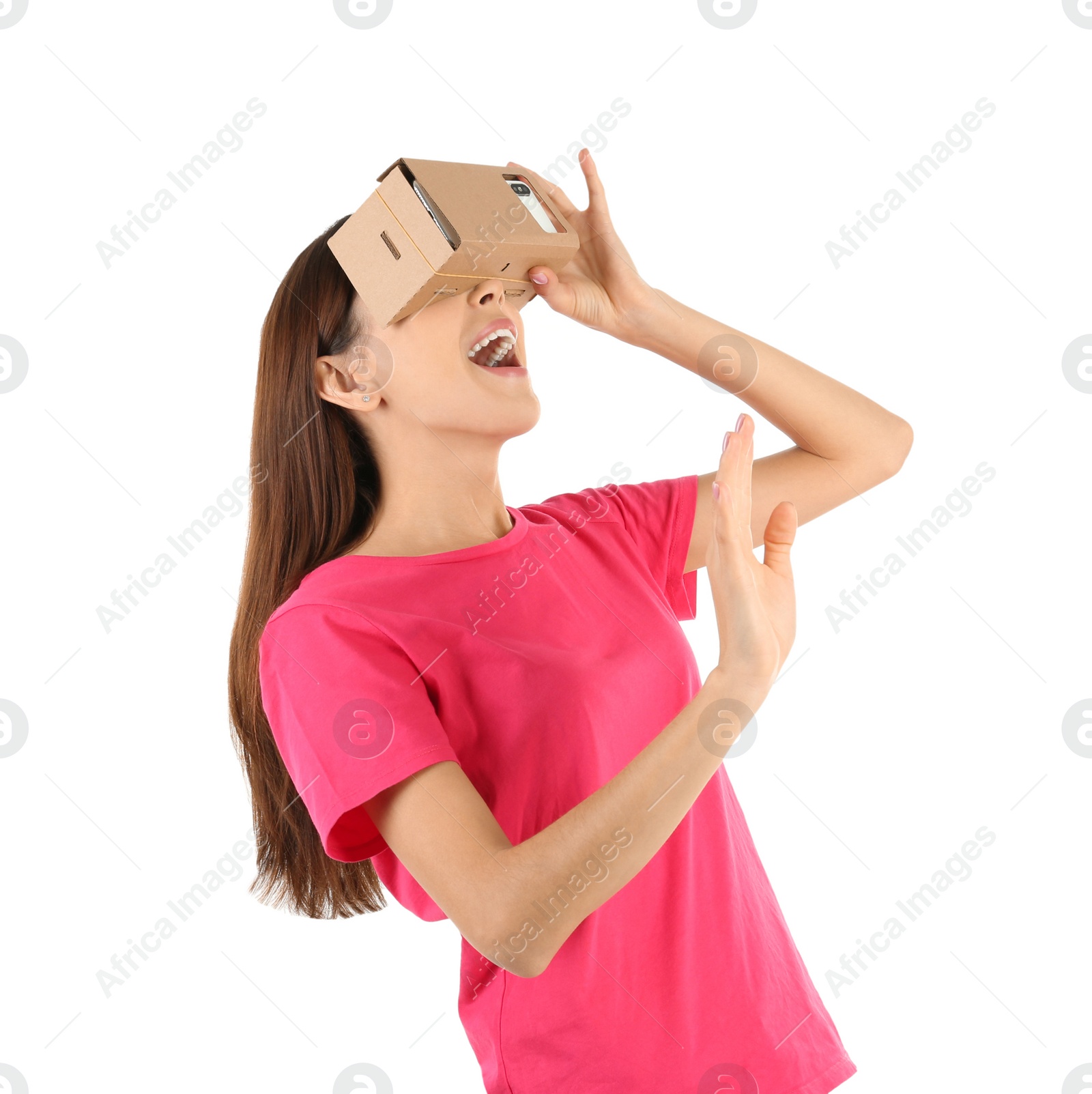 Photo of Young woman using cardboard virtual reality headset, isolated on white