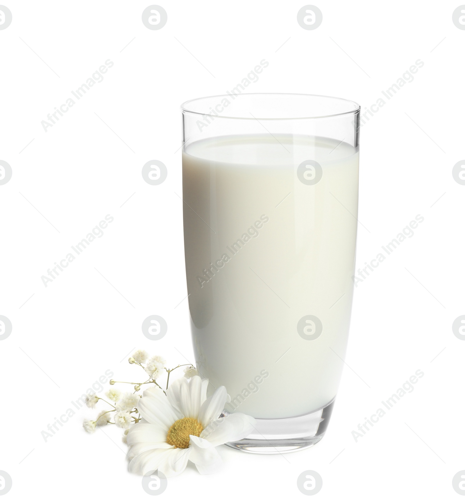 Photo of Glass with milk and flowers on white background