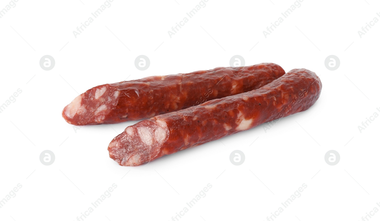 Photo of Thin dry smoked sausages isolated on white