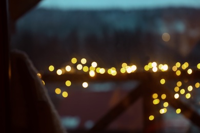 Photo of Blurred view of fence decorated with Christmas lights