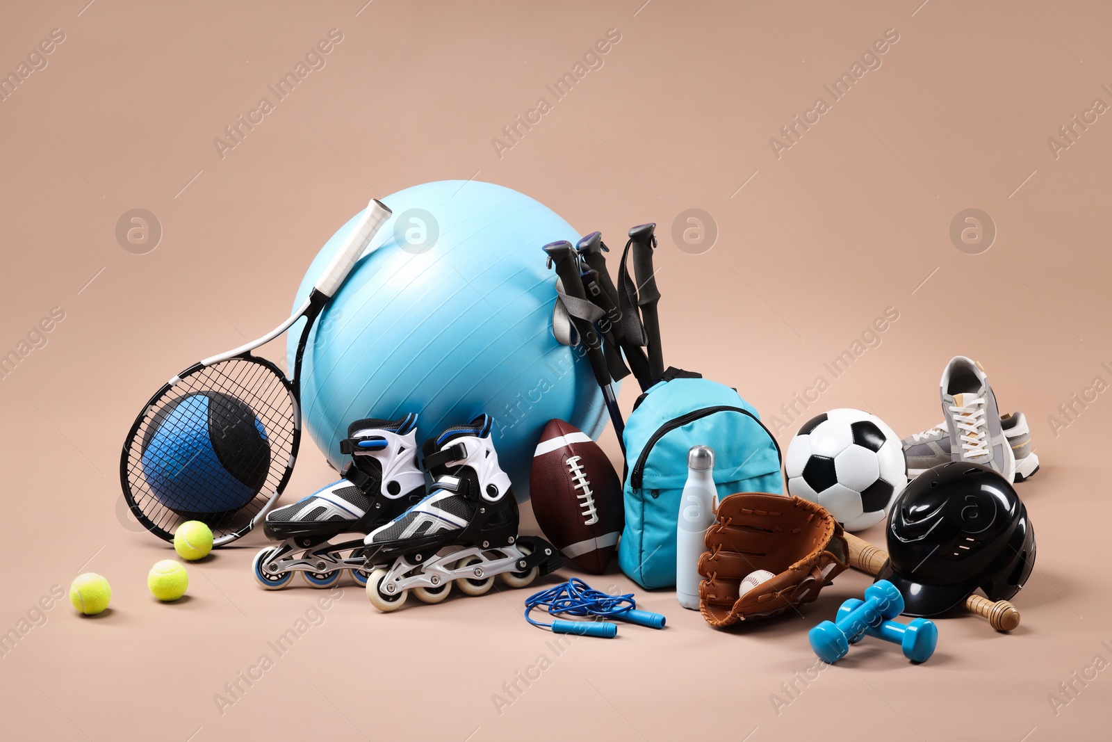 Photo of Many different sports equipment on beige background