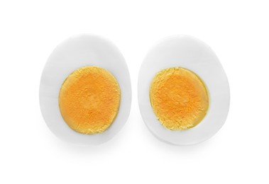 Halves of fresh hard boiled egg on white background, top view