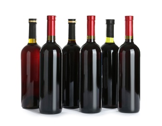 Photo of Bottles with red wine on white background