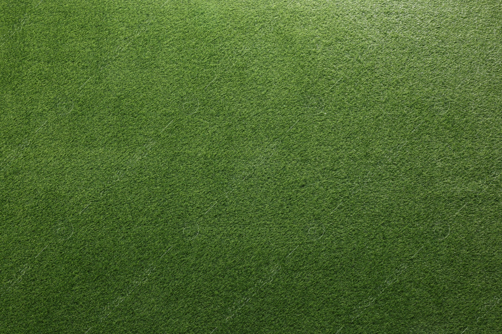 Photo of Green artificial grass as background, top view