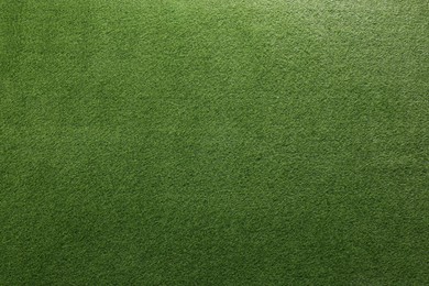 Photo of Green artificial grass as background, top view