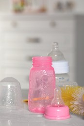 Photo of Clean baby bottles and nipples after sterilization on white table