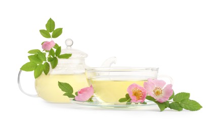 Aromatic herbal tea in glass cup, teapot, flowers and green leaves isolated on white