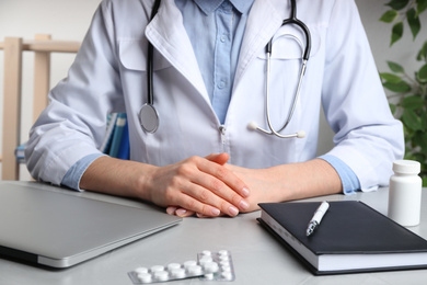 Photo of Doctor working at desk in office, closeup. Medical service