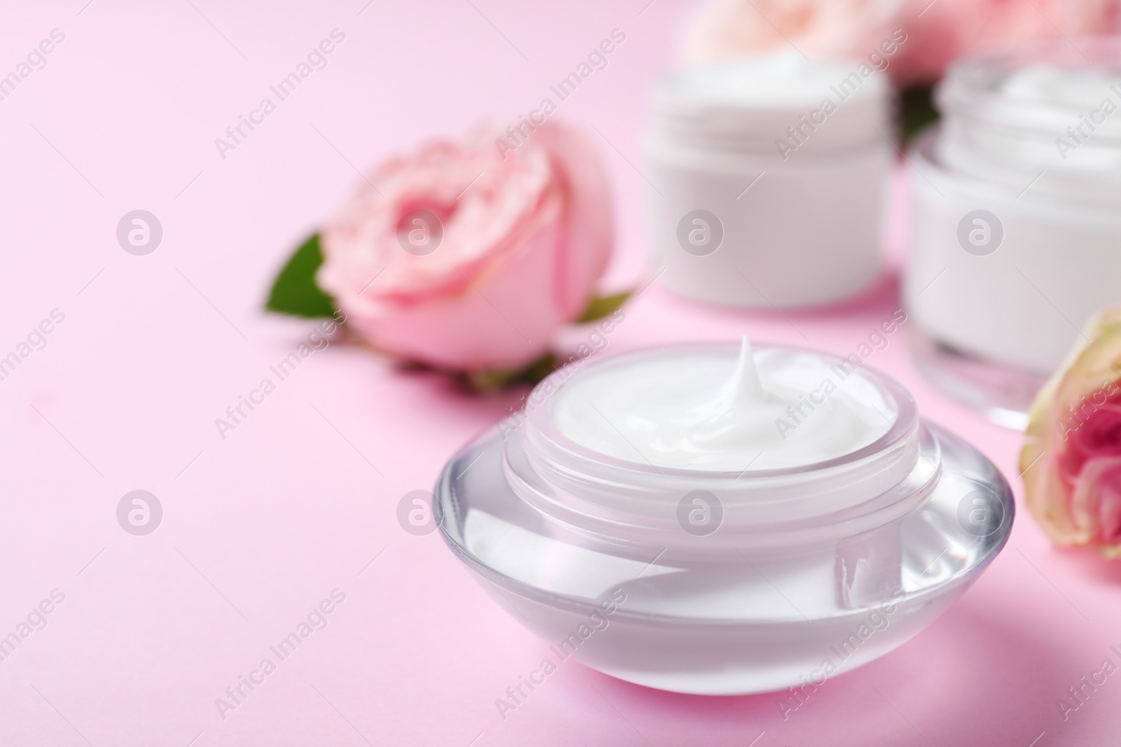 Photo of Jar of organic cream on pink background. Space for text