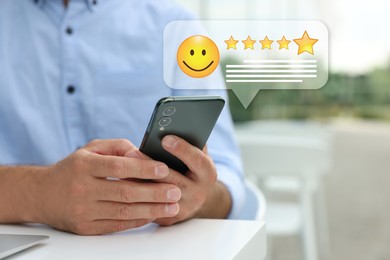 Man leaving service feedback with smartphone, closeup. Stars and emoticon over device