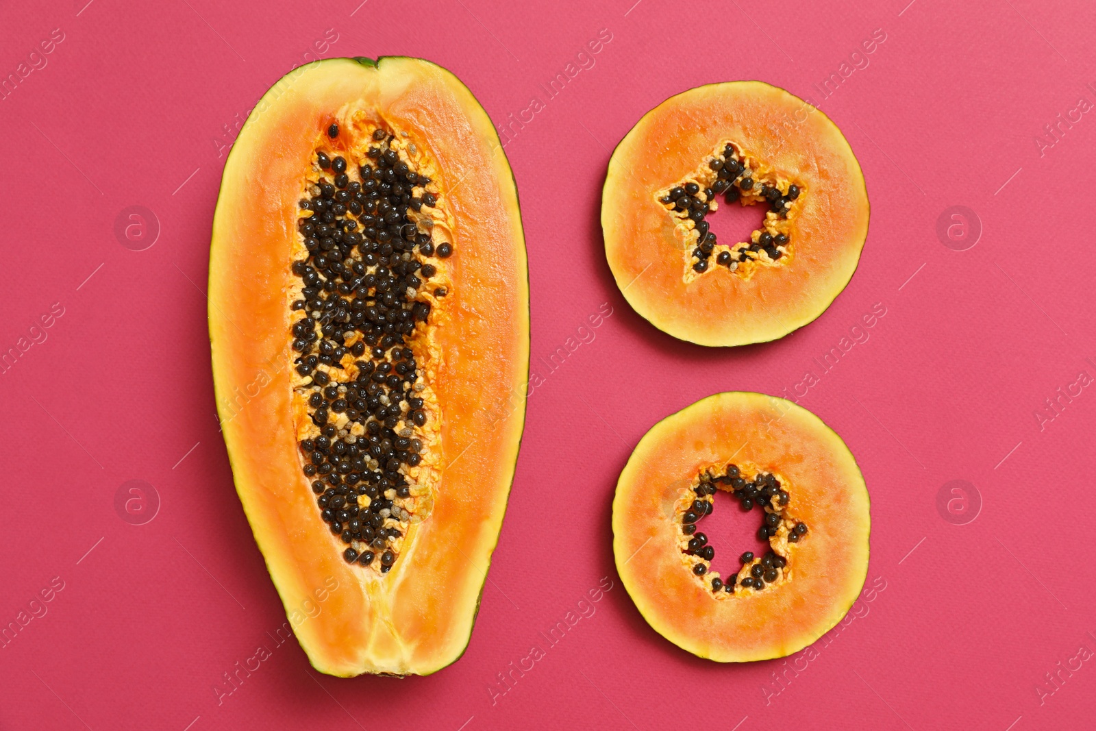 Photo of Flat lay composition with cut papaya on pink background