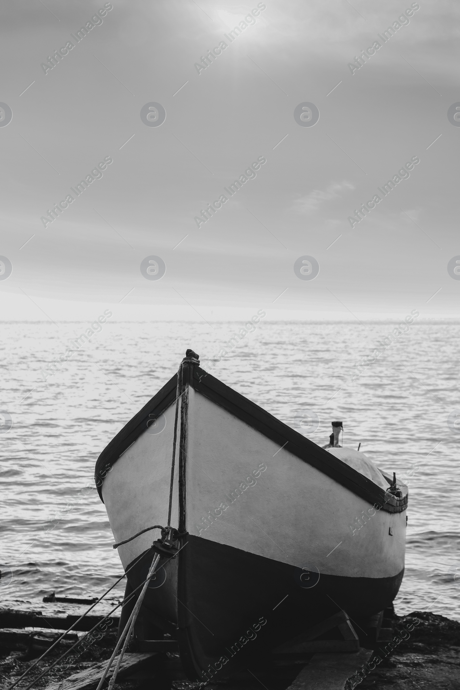 Image of Moored boat on beach near sea outdoors. Black and white effect