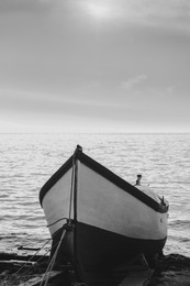 Image of Moored boat on beach near sea outdoors. Black and white effect