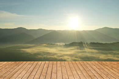 Image of Empty wooden surface and beautiful view of misty mountain landscape