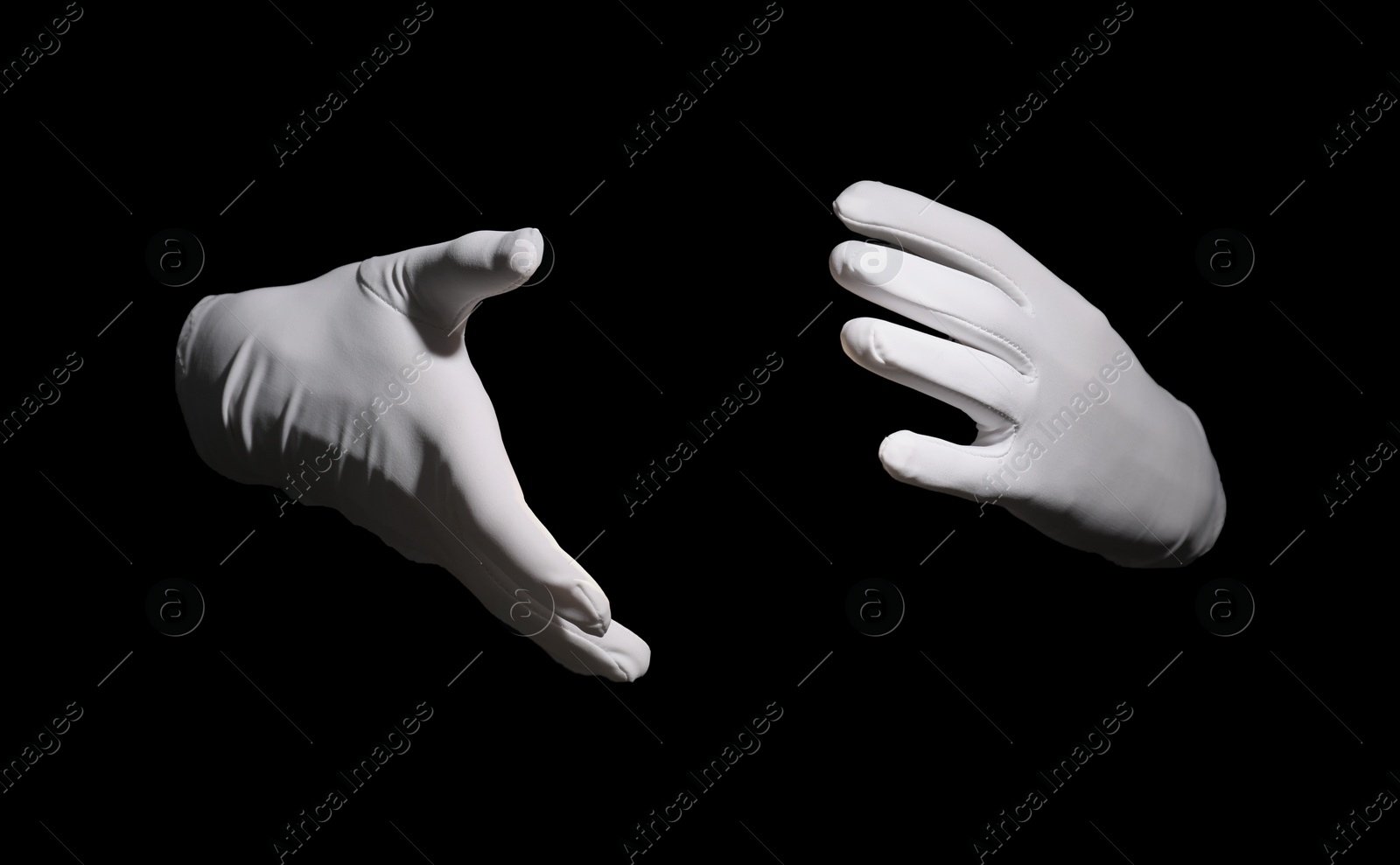 Photo of Magician holding something on black background, closeup