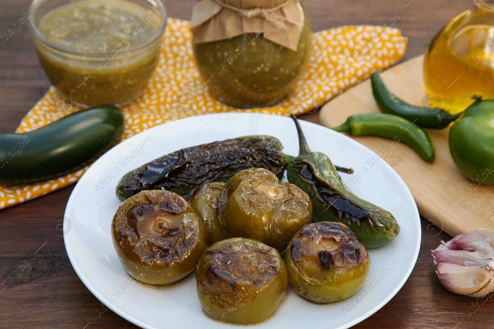 Photo of Different ingredients and tasty salsa sauce on wooden table