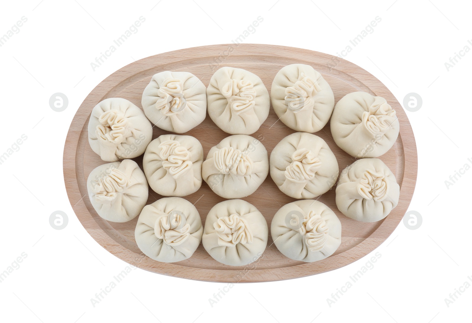 Photo of Board with uncooked khinkali (dumplings) isolated on white, top view. Georgian cuisine