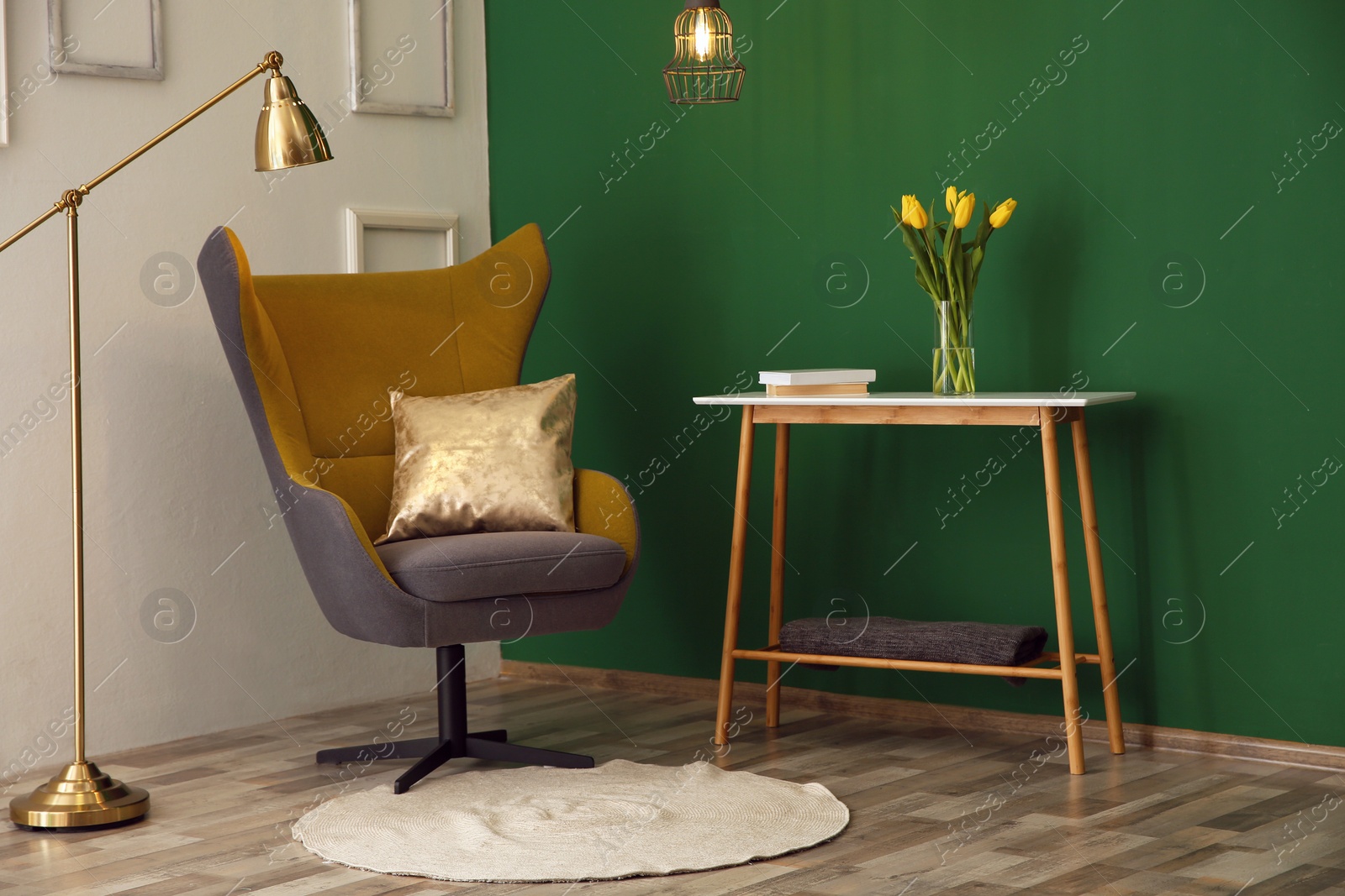 Photo of Modern interior with comfortable armchair and table near color wall