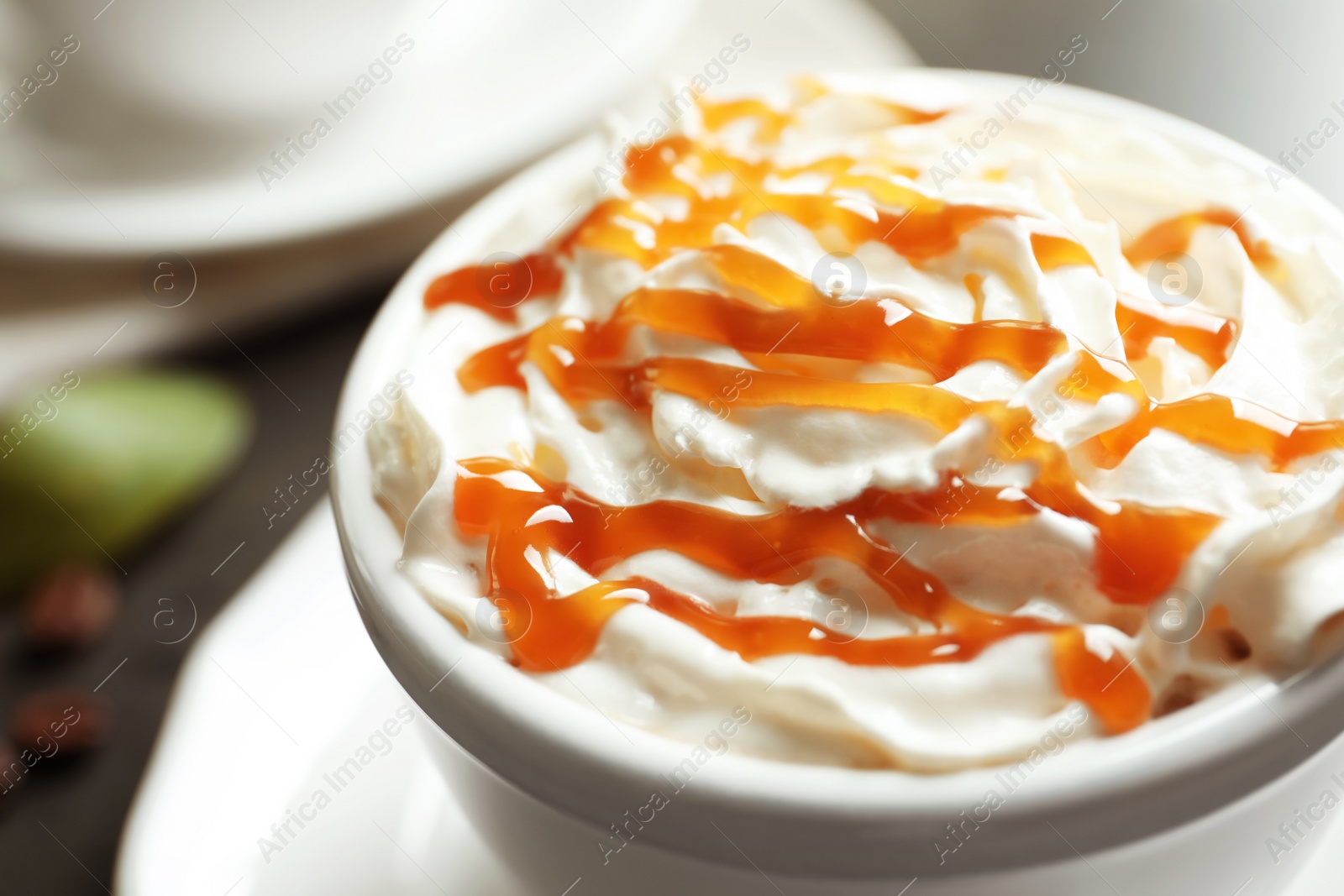 Photo of Cup of coffee with caramel topping, closeup