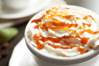 Photo of Cup of coffee with caramel topping, closeup