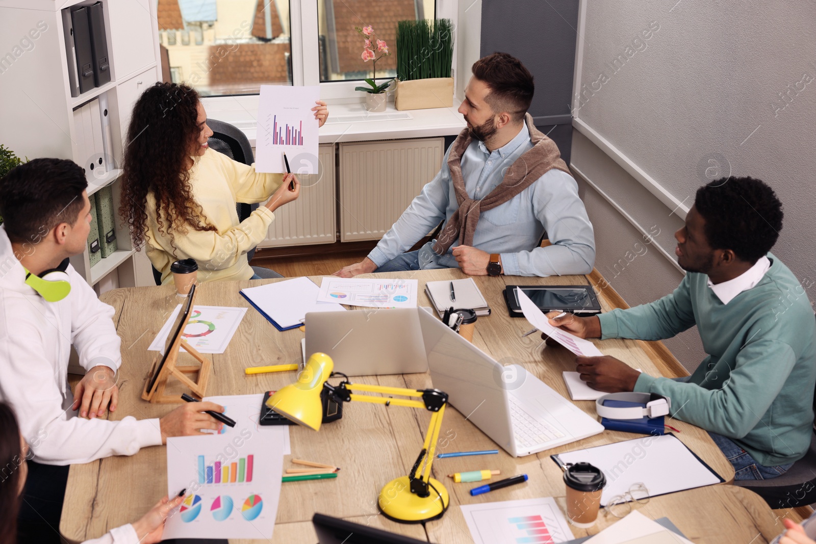 Photo of Team of employees working together in office. Startup project