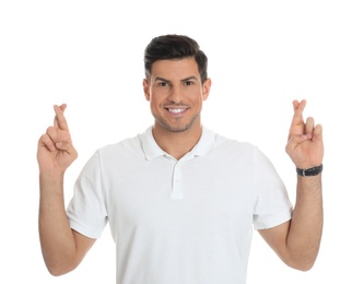 Man with crossed fingers on white background. Superstition concept