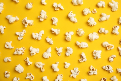 Photo of Tasty fresh popcorn on color background, top view