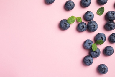 Flat lay composition with tasty blueberry and space for text on color background