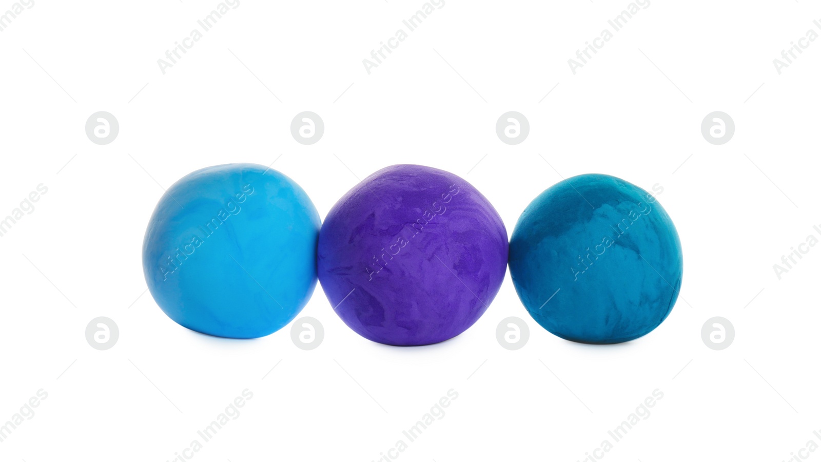 Photo of Row of color play dough balls isolated on white