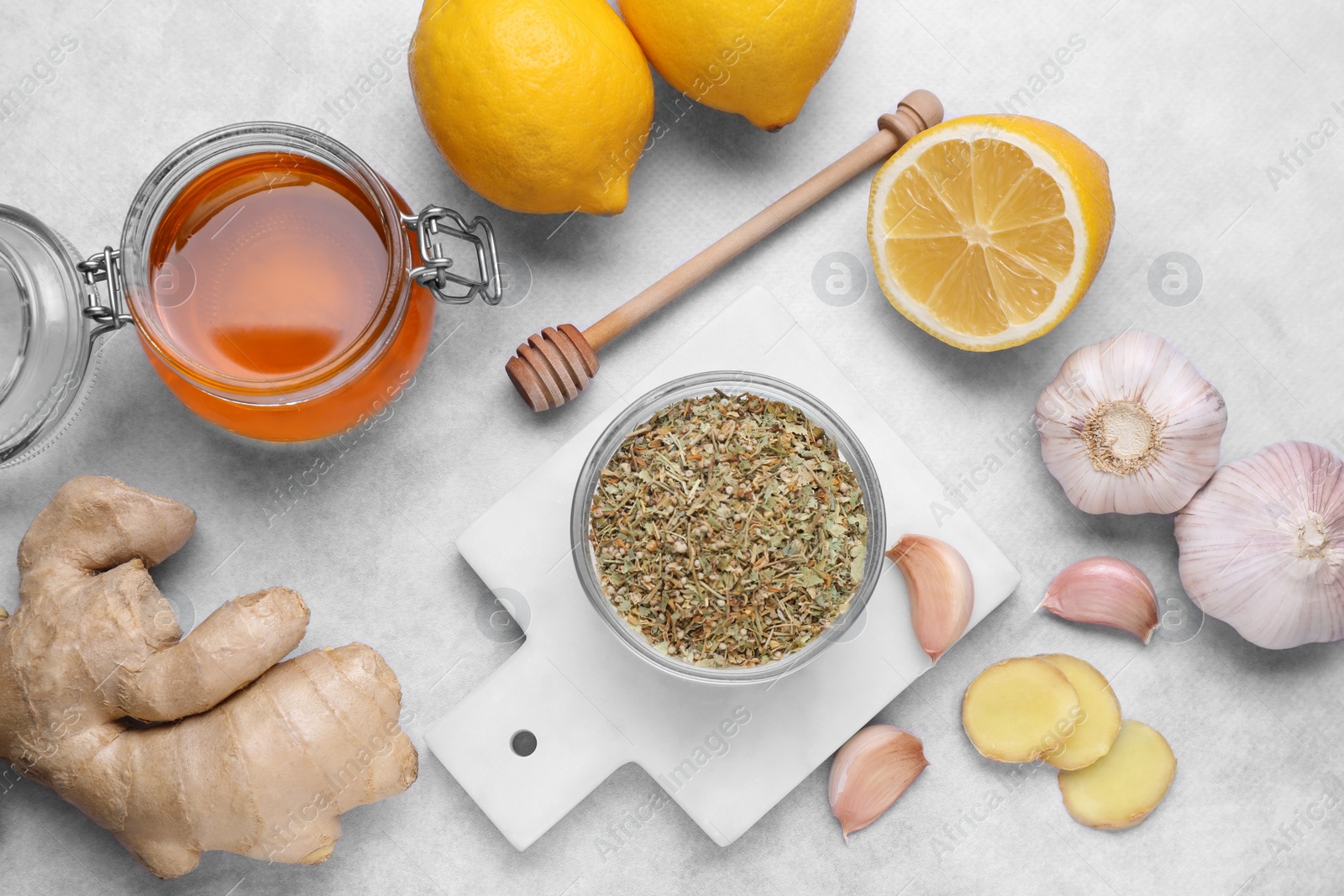 Photo of Different natural cold remedies on light grey table, flat lay. Cough treatment