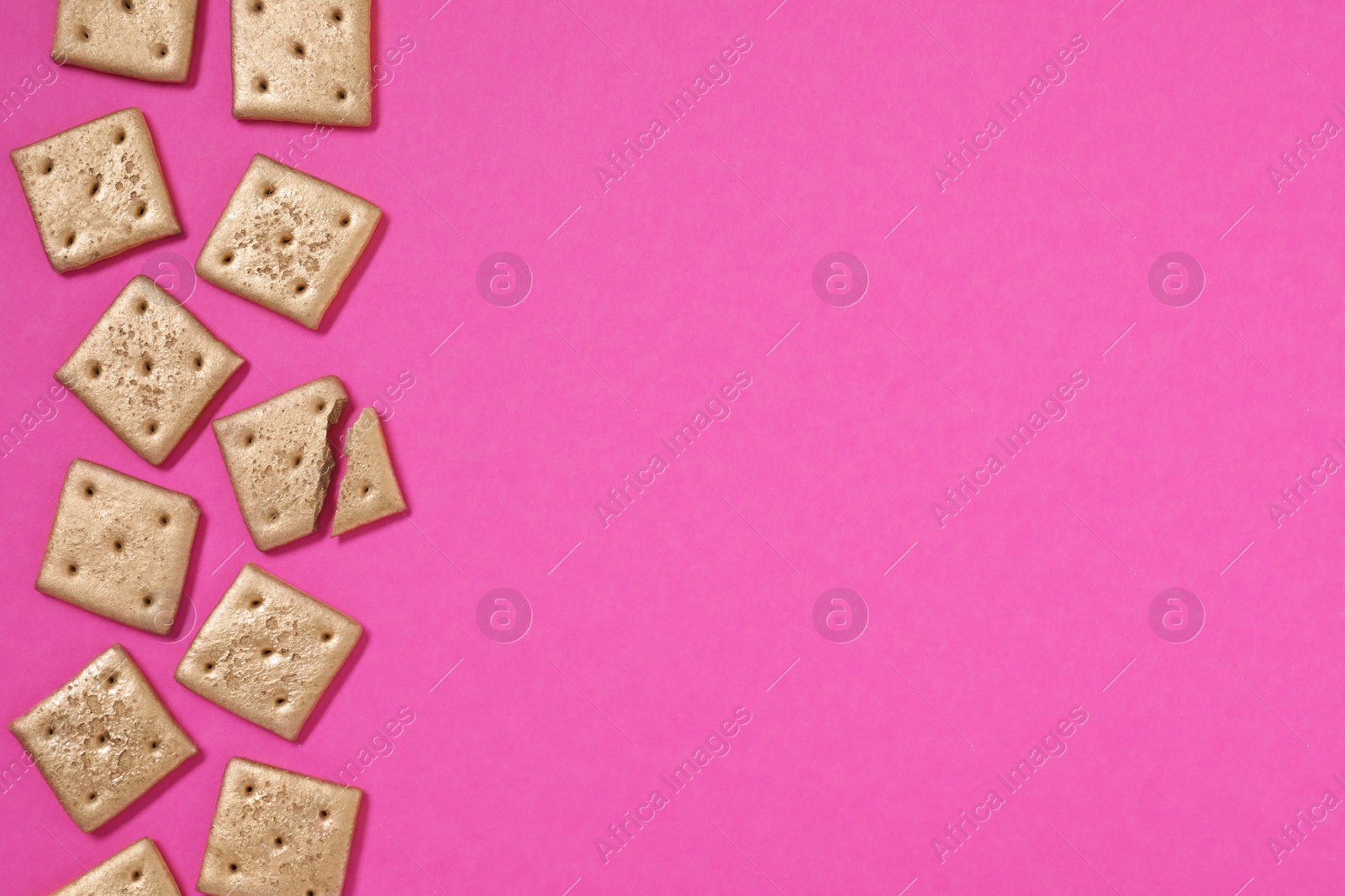 Photo of Golden cookies on pink background, flat lay. Space for text